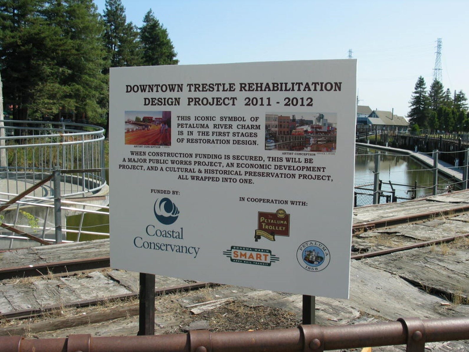 A 2011–2012 project sign on the trestle announcing the Downtown Trestle Rehabilitation Design Project, funded by the California Coastal Conservancy.