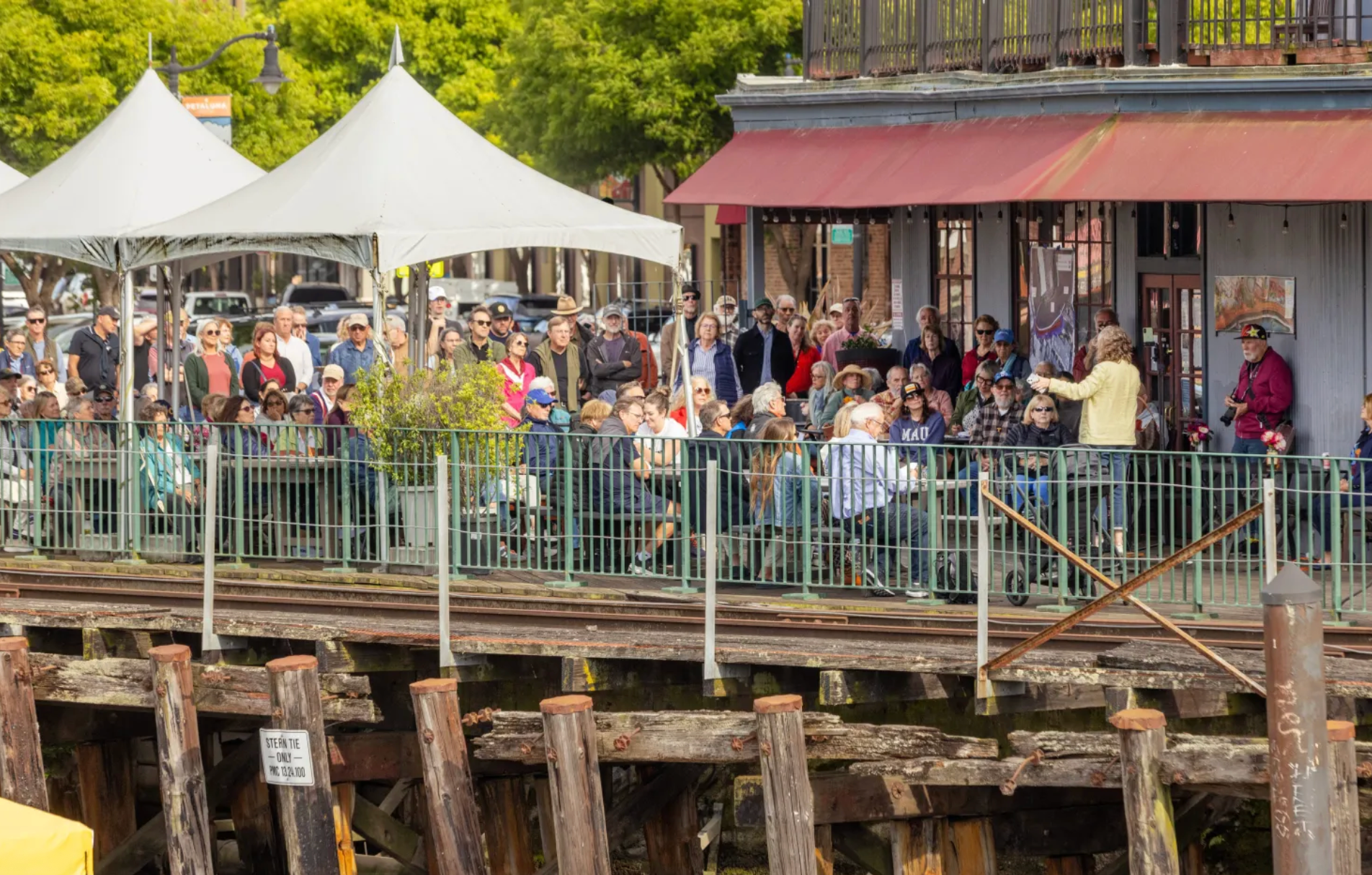 Picture of Trestle with many people gathered to hear the Kick off event for Petaluma Riverfront Trestle Now committee.